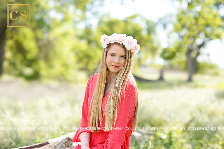 Oak Ridge senior in the class of 2017, wearing a coral romper, hat, floral crown in El Dorado Hills, features oak trees and grasses, by senior photographer Colleen Sanders.