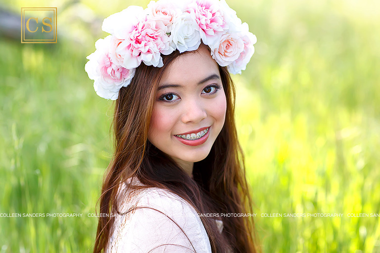 Oak Ridge senior looking flawless in hair pale pink shirt in the class of 2017, wearing a floral crown in El Dorado Hills, features oak trees and grasses, by senior photographer Colleen Sanders.